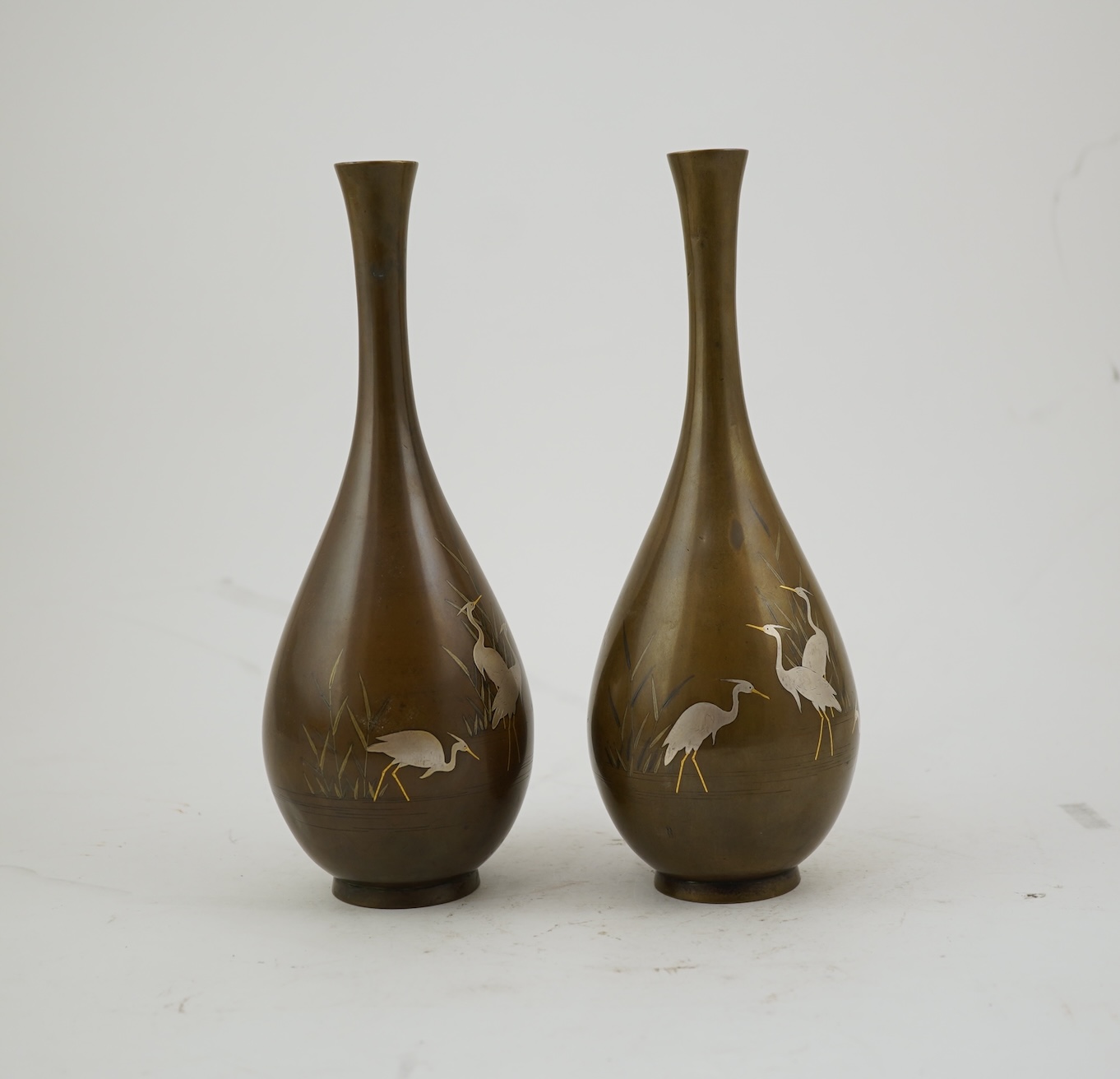 A pair of Japanese bronze and mixed metal inlaid bottle vases, signed Hidemitsu, Meiji period